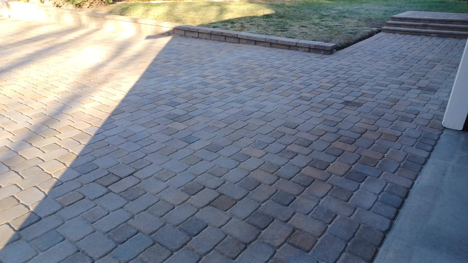 Driveway and porch paver project with a landscaped front yard
